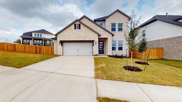 craftsman house with a garage and a front lawn