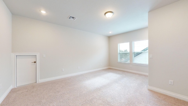 empty room with light colored carpet