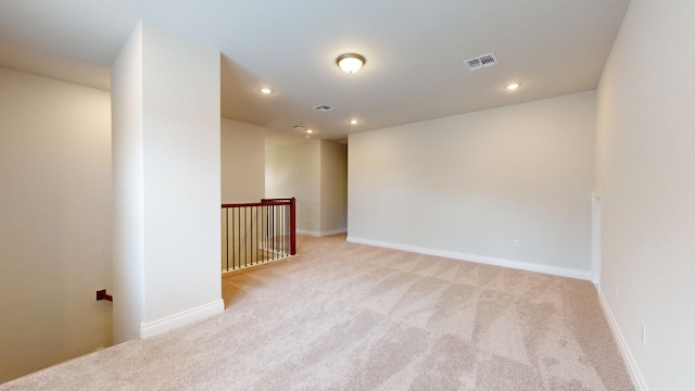 unfurnished room with light colored carpet