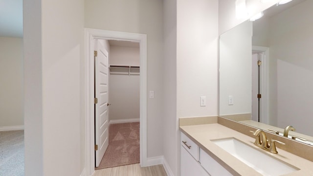 bathroom with hardwood / wood-style floors and vanity