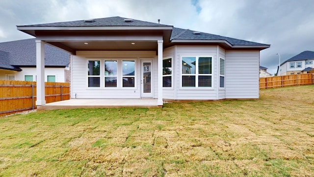 back of property featuring a yard and a patio area