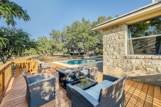 deck featuring an outdoor living space with a fire pit