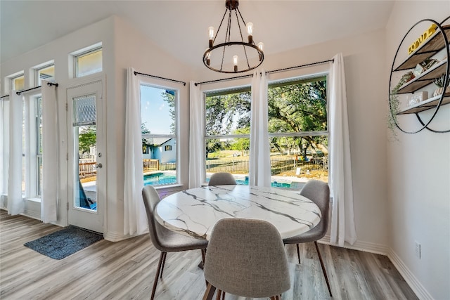 dining area featuring a chandelier, light hardwood / wood-style flooring, and plenty of natural light