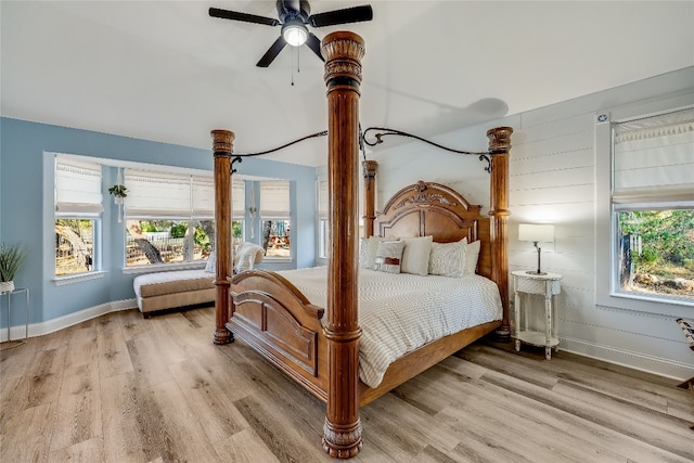 bedroom with multiple windows, light wood-type flooring, and ceiling fan