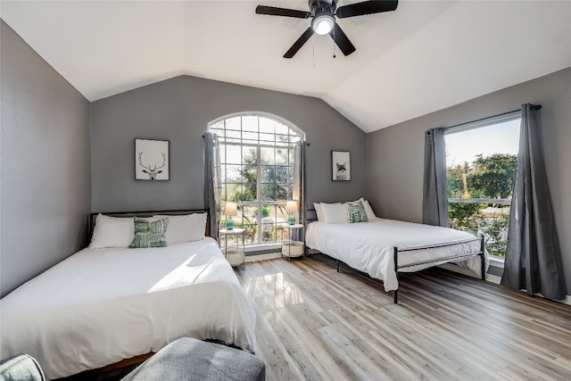 bedroom featuring ceiling fan, light hardwood / wood-style flooring, and multiple windows