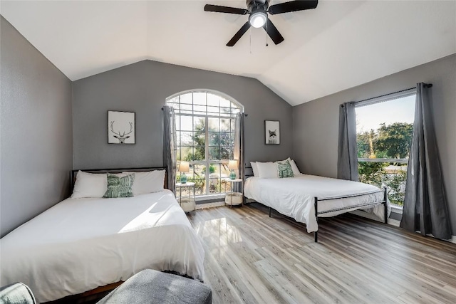3110 Point Cv, Lago Vista, TX 78645 - bedroom with lofted ceiling, light wood-style flooring, multiple windows, and ceiling fan