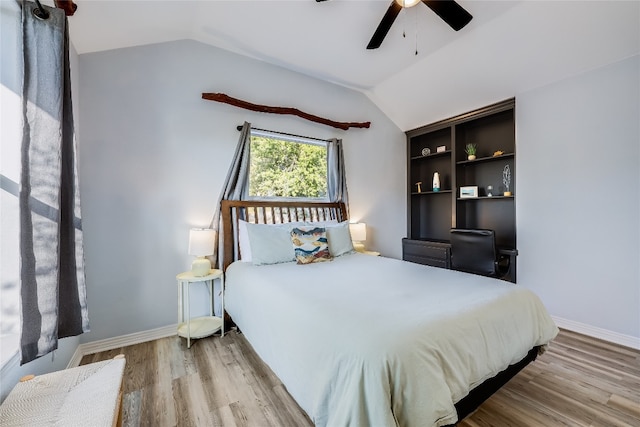 bedroom featuring ceiling fan, lofted ceiling, and light hardwood / wood-style flooring