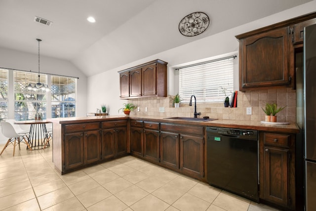 kitchen with lofted ceiling, hanging light fixtures, sink, tasteful backsplash, and black dishwasher