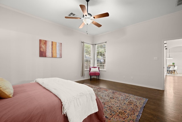 bedroom featuring ceiling fan, dark hardwood / wood-style floors, and ornamental molding