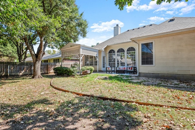 back of house with a lawn and a patio area