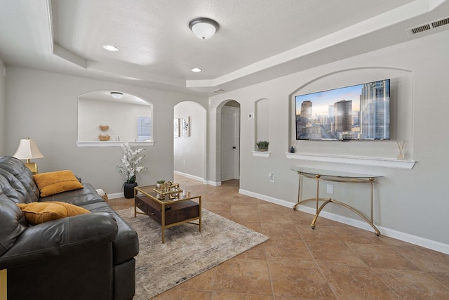 living room featuring a tray ceiling