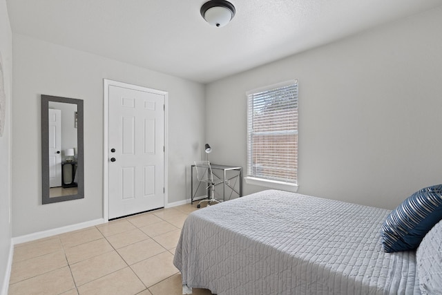 bedroom featuring light tile patterned flooring