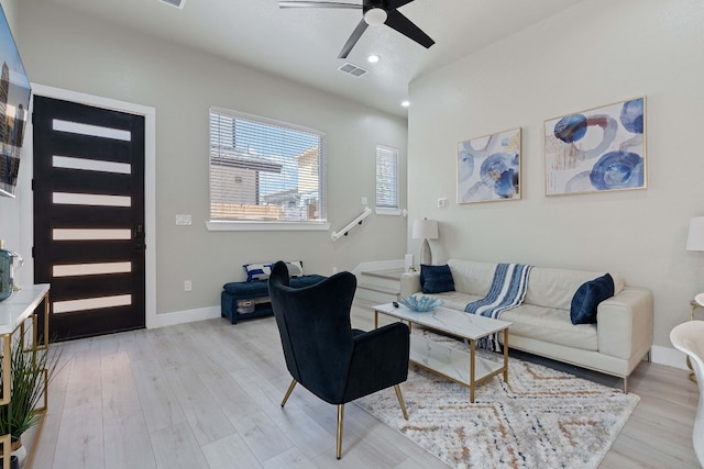 living room featuring ceiling fan and light wood-type flooring