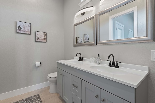 bathroom featuring vanity, tile patterned flooring, and toilet