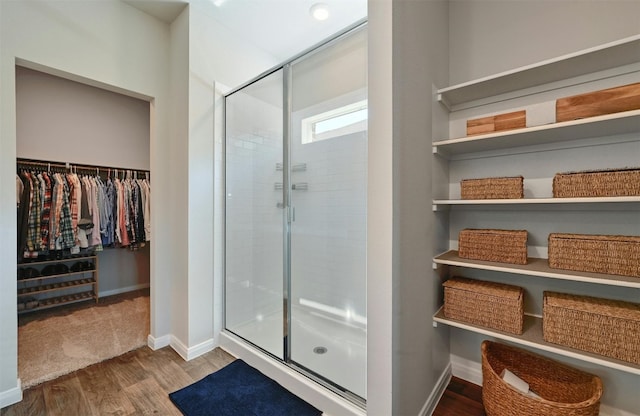 bathroom featuring walk in shower and wood-type flooring