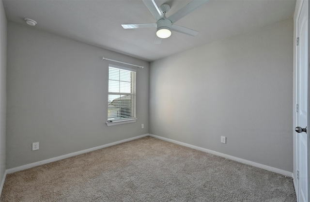 spare room featuring ceiling fan and light colored carpet