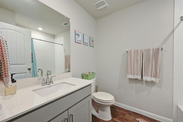 bathroom with vanity, hardwood / wood-style floors, and toilet