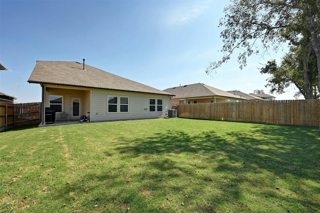 rear view of house featuring a yard, central air condition unit, and a patio area