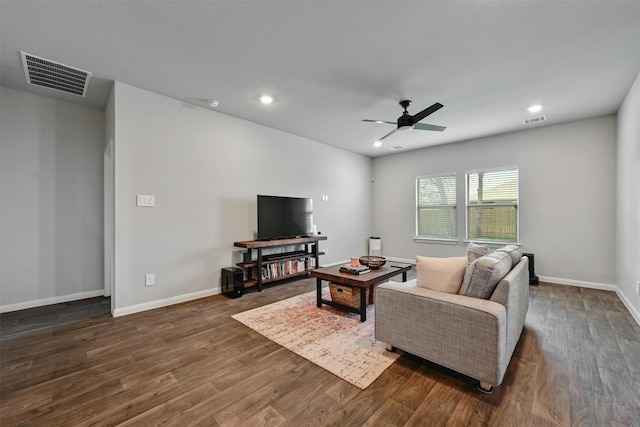 living room featuring ceiling fan and dark hardwood / wood-style flooring