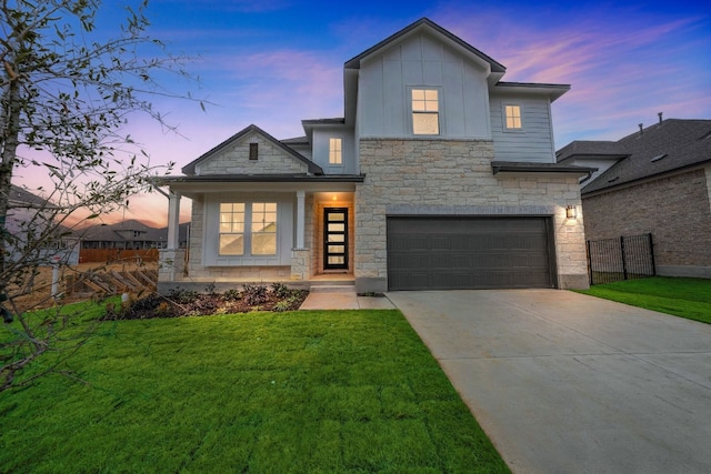 view of front of property with a yard and a garage