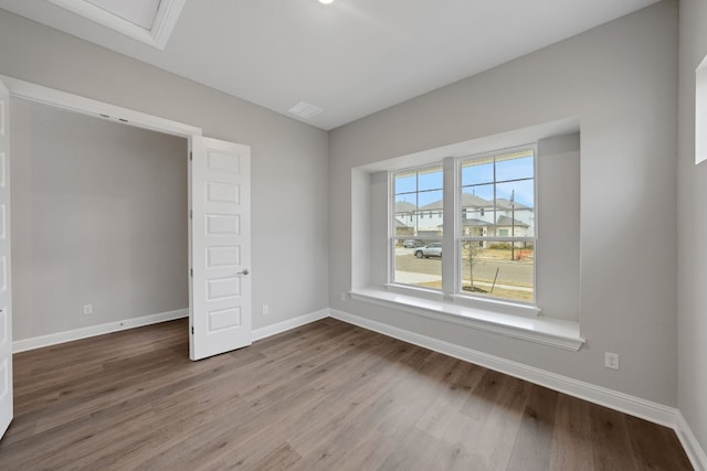 empty room with hardwood / wood-style flooring