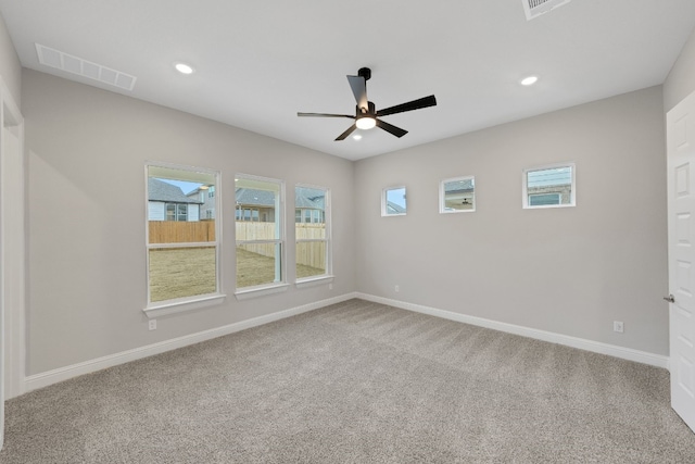 spare room featuring carpet floors and ceiling fan