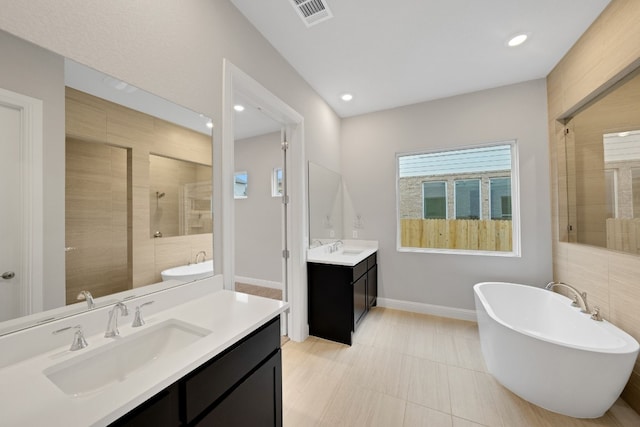 bathroom with independent shower and bath and vanity