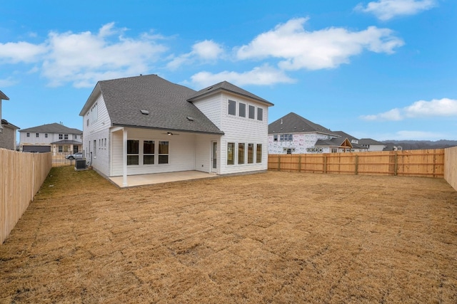 rear view of property featuring a lawn and a patio