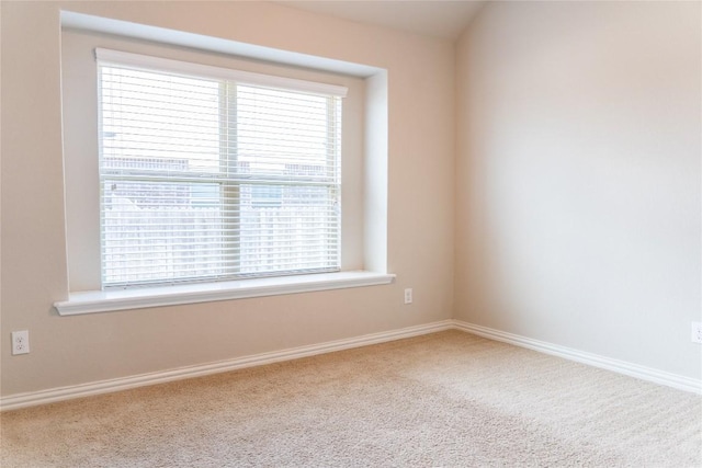 unfurnished room with a wealth of natural light and carpet