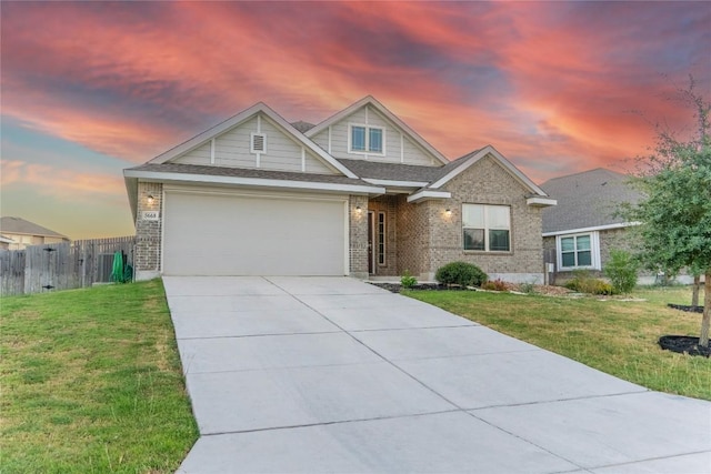 view of front of property featuring a lawn and a garage