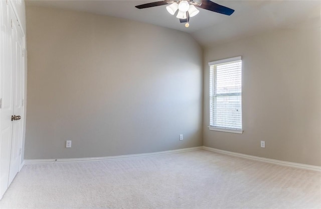 carpeted empty room featuring ceiling fan and vaulted ceiling