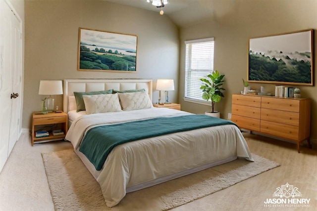 bedroom with light carpet, a closet, and lofted ceiling