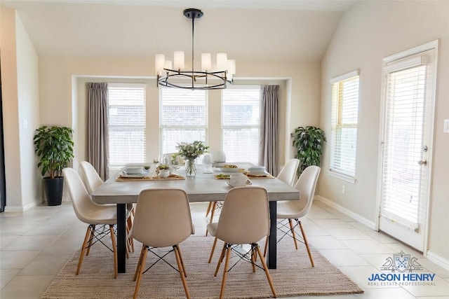 tiled dining area featuring plenty of natural light, lofted ceiling, and a chandelier