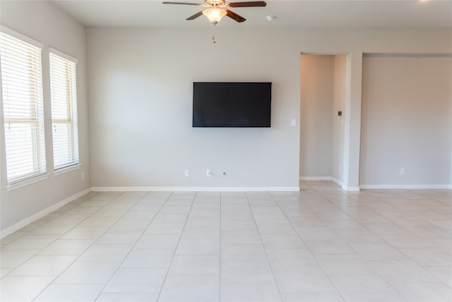 unfurnished room featuring plenty of natural light, ceiling fan, and light tile patterned floors