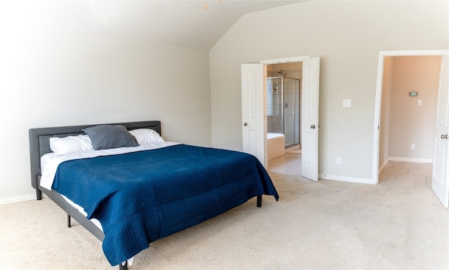 carpeted bedroom featuring vaulted ceiling and ensuite bath