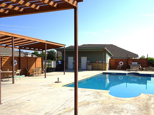 view of swimming pool featuring a patio area and a pergola