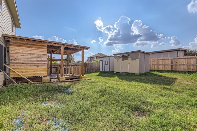 view of yard with a shed and a wooden deck