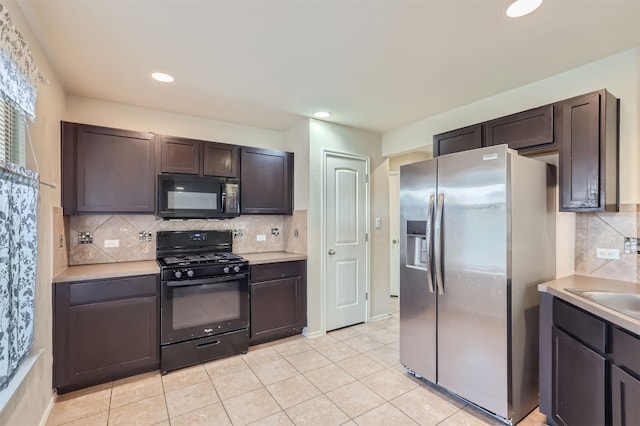 kitchen featuring black appliances, light tile patterned flooring, and tasteful backsplash