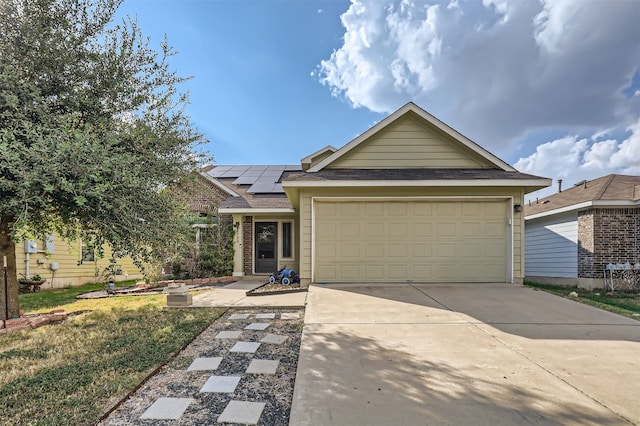 view of front of home with a garage and solar panels