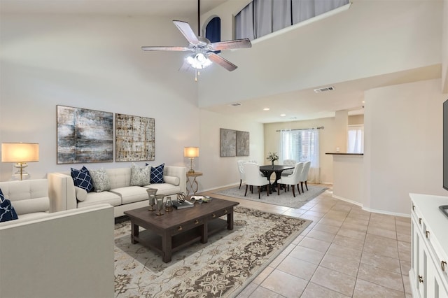 tiled living room featuring high vaulted ceiling and ceiling fan