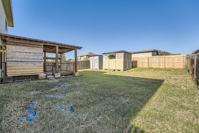 view of yard with a storage unit and a wooden deck