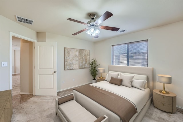 bedroom with ceiling fan and light colored carpet