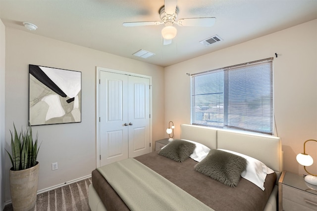 bedroom with dark carpet, a closet, and ceiling fan