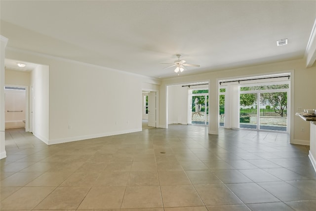 unfurnished room featuring ceiling fan and light tile patterned floors