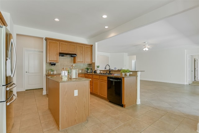 kitchen with stainless steel refrigerator, backsplash, dishwasher, light tile patterned floors, and a center island