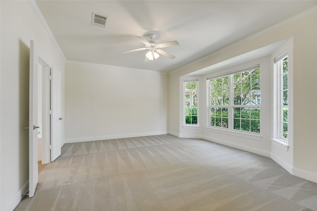 carpeted empty room featuring crown molding and ceiling fan