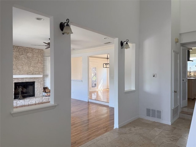 interior space featuring ornamental molding, sink, and light hardwood / wood-style floors