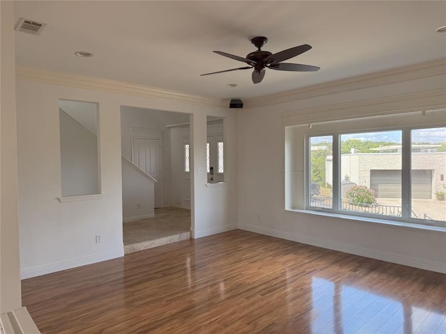 unfurnished room featuring ceiling fan, ornamental molding, and wood-type flooring