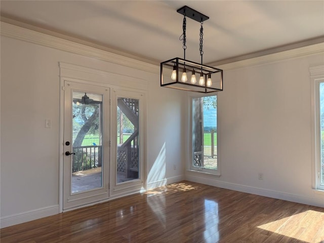 unfurnished dining area with dark wood-type flooring and ornamental molding