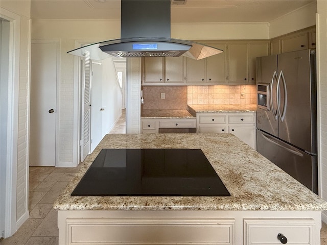 kitchen featuring island exhaust hood, black electric cooktop, stainless steel refrigerator with ice dispenser, a center island, and light stone countertops